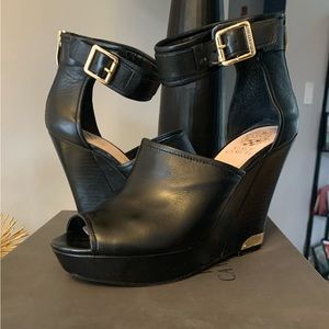 Women’s black and gold anklestrap platform heels by Vince Camaro.